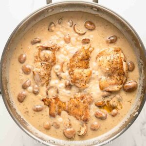 Creamy chicken in mushroom soup in a skillet.