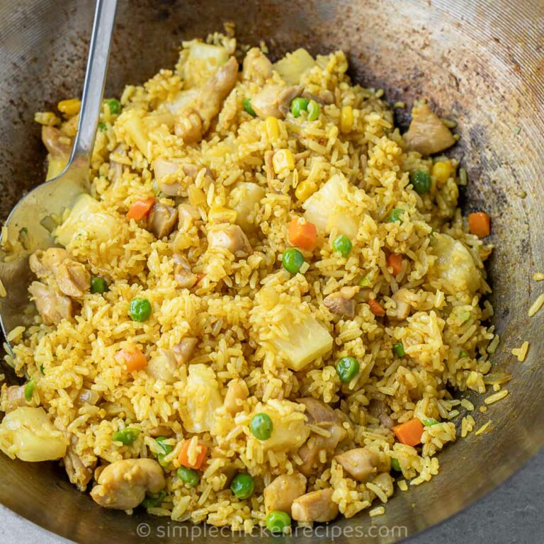 fried rice with pineapple, chicken, and vegetables.